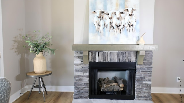 interior details with hardwood / wood-style flooring and a brick fireplace