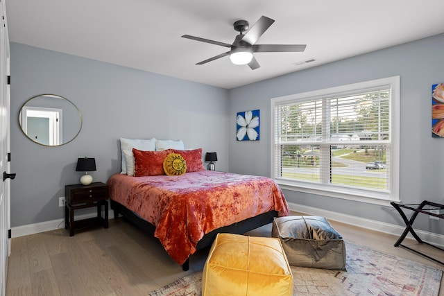 bedroom with ceiling fan and light hardwood / wood-style floors