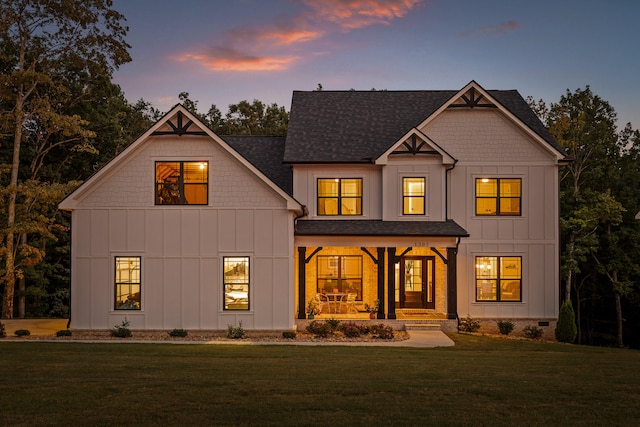 view of front of home with a yard and a porch