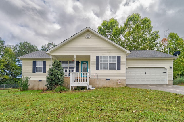 view of front of house with a garage, a front lawn, and covered porch