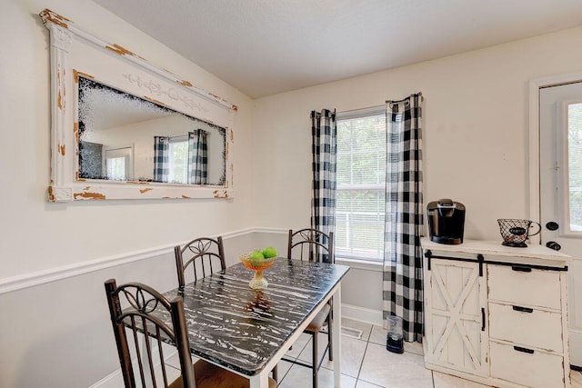 dining area with light tile patterned floors