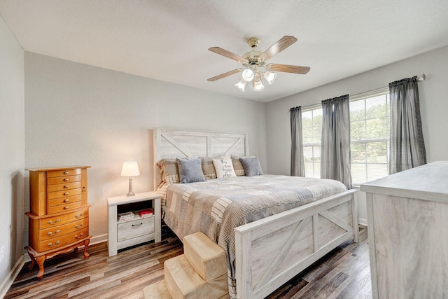 bedroom with ceiling fan and hardwood / wood-style floors