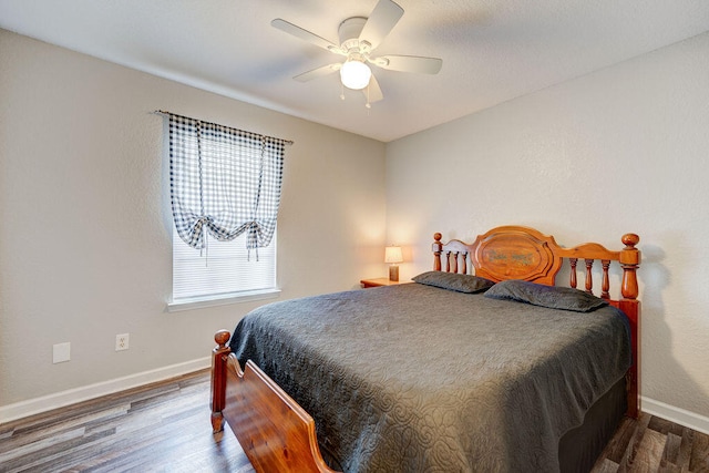 bedroom with ceiling fan and hardwood / wood-style floors