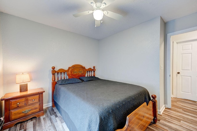 bedroom with ceiling fan and light hardwood / wood-style flooring