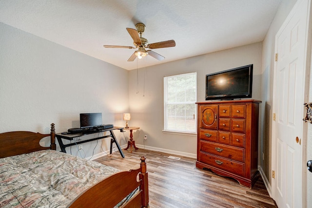 bedroom featuring ceiling fan and hardwood / wood-style flooring