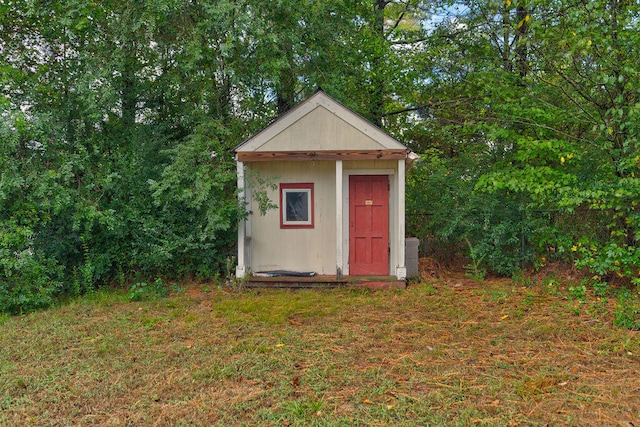 view of outbuilding with a yard