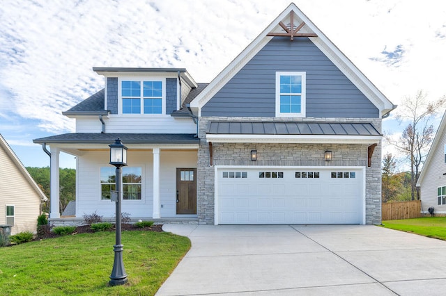 view of front of property with a front yard, a porch, and a garage