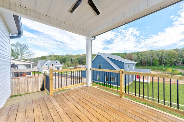 wooden deck with ceiling fan and a yard