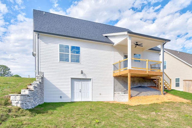 back of house featuring a lawn, ceiling fan, and a deck