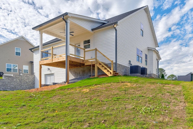 rear view of property featuring a yard and a deck