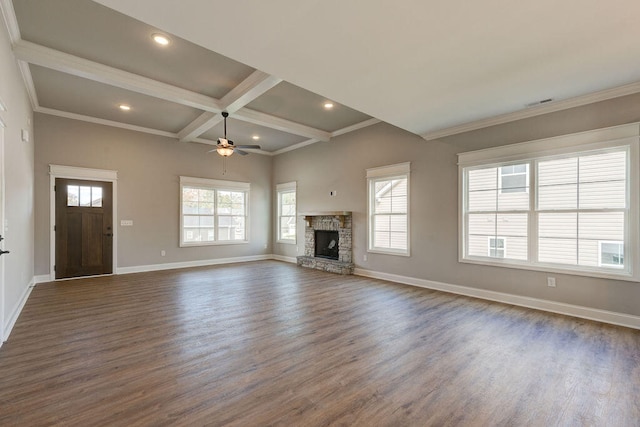 unfurnished living room with ceiling fan, plenty of natural light, dark wood-type flooring, and coffered ceiling