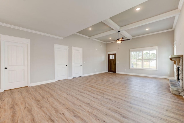 unfurnished living room with light wood-type flooring, ceiling fan, crown molding, beamed ceiling, and a stone fireplace