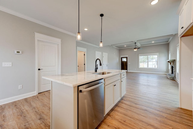 kitchen with a center island with sink, white cabinets, stainless steel dishwasher, and sink