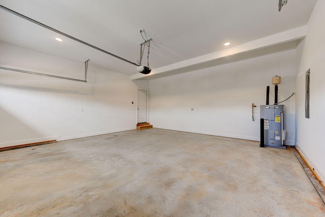 garage with a garage door opener and electric water heater