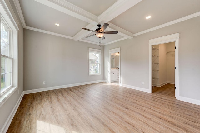 unfurnished bedroom featuring light wood-type flooring, ceiling fan, a spacious closet, beamed ceiling, and a closet