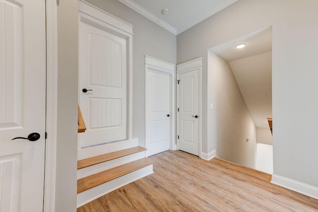 stairs featuring hardwood / wood-style floors and ornamental molding