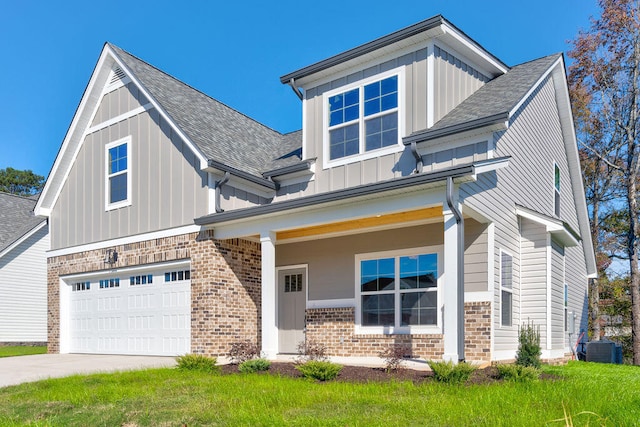 view of front of home with cooling unit and a garage