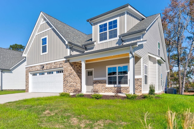 craftsman-style house featuring central air condition unit, a front lawn, and a garage