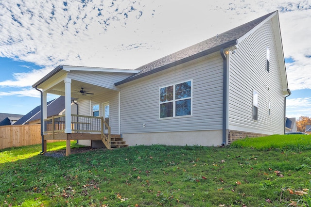 exterior space featuring ceiling fan and a lawn