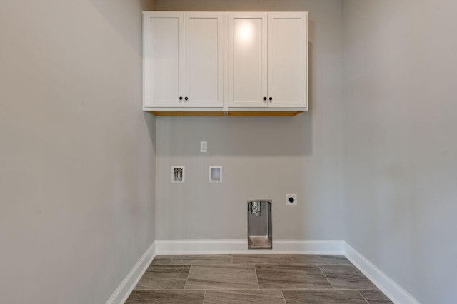 washroom featuring cabinets, hookup for a washing machine, and electric dryer hookup