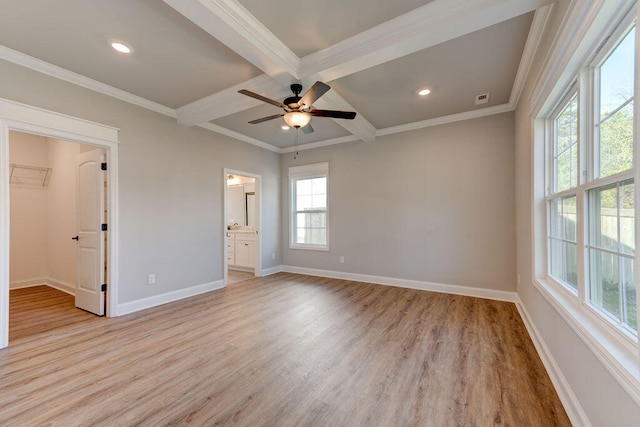 unfurnished bedroom featuring beam ceiling, ceiling fan, light hardwood / wood-style floors, a walk in closet, and a closet