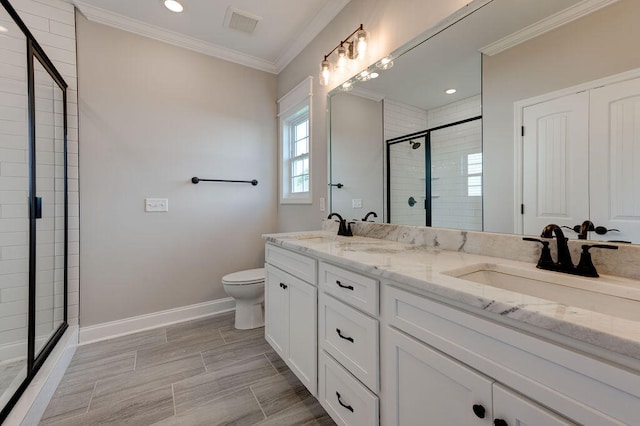 bathroom featuring toilet, vanity, an enclosed shower, and ornamental molding