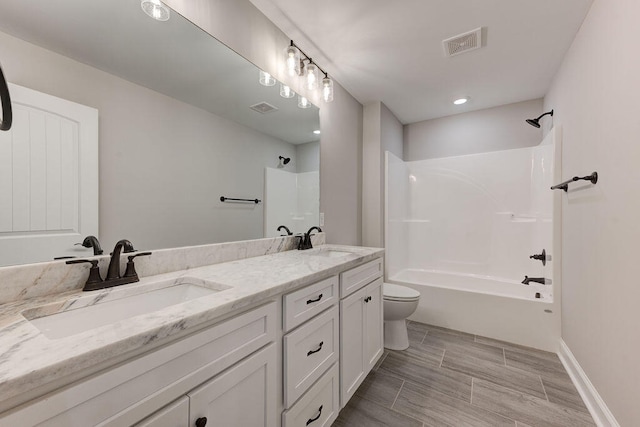 full bathroom featuring vanity,  shower combination, and toilet