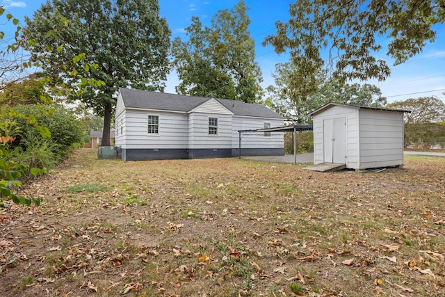 back of property with a shed and central air condition unit