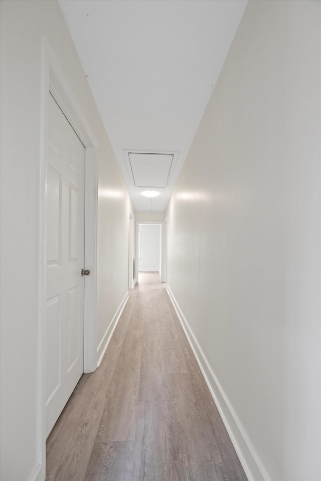 corridor with light hardwood / wood-style flooring