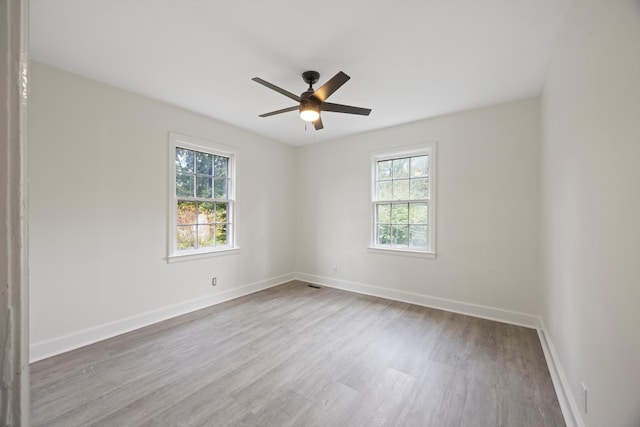 unfurnished room with ceiling fan, light hardwood / wood-style floors, and a wealth of natural light