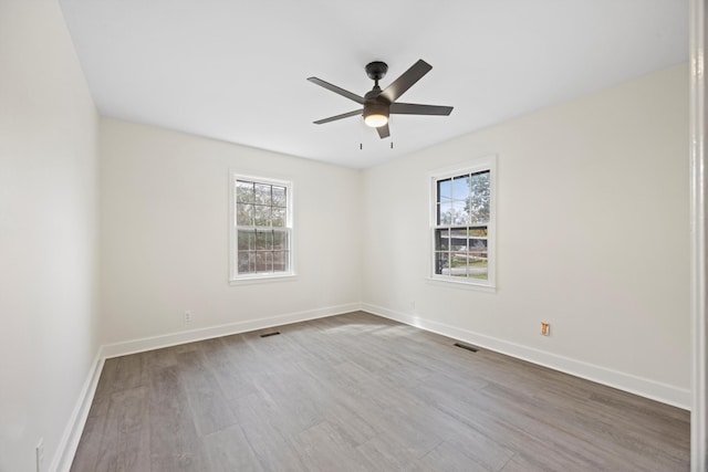 unfurnished room featuring ceiling fan and hardwood / wood-style flooring