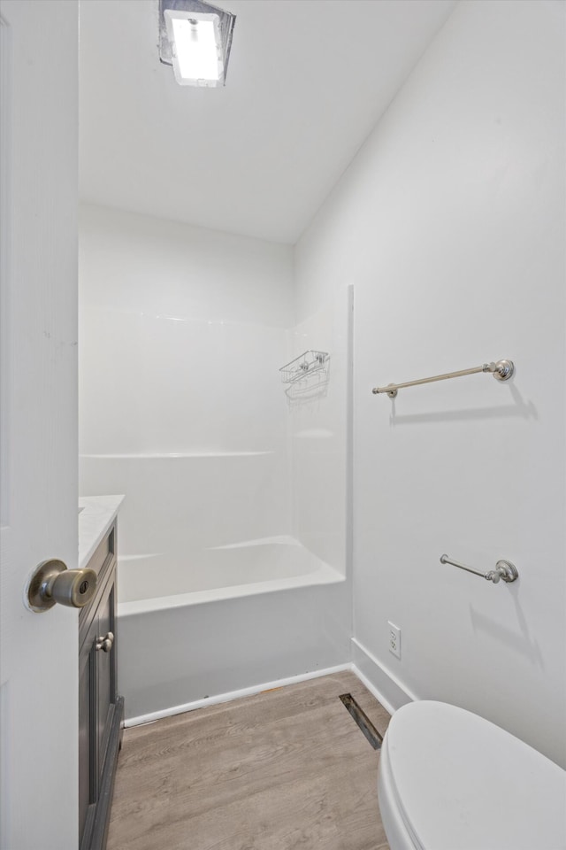 full bathroom with wood-type flooring, vanity, toilet, and shower / washtub combination