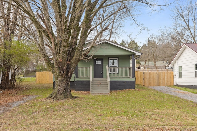 bungalow-style home featuring a front yard and a porch