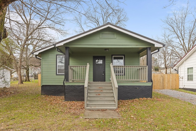 bungalow-style house with a porch and a front lawn