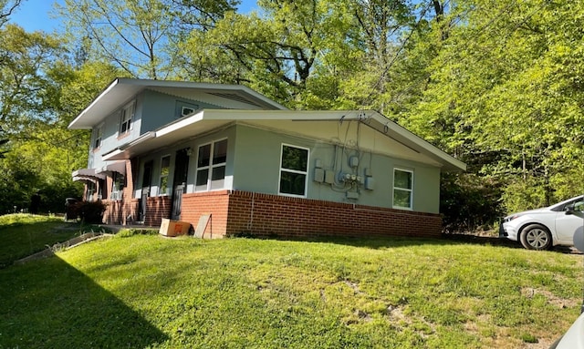 view of side of home with a lawn