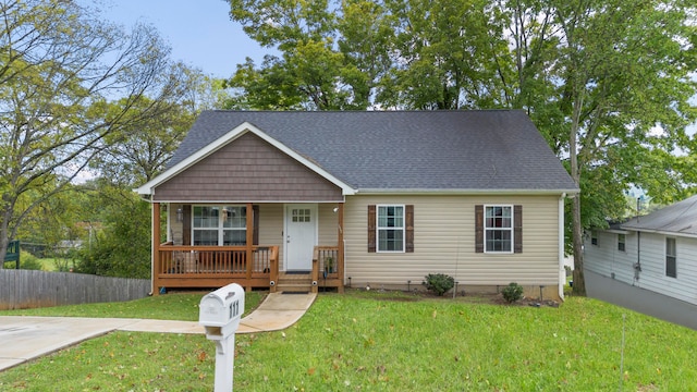 view of front facade with a front yard and covered porch