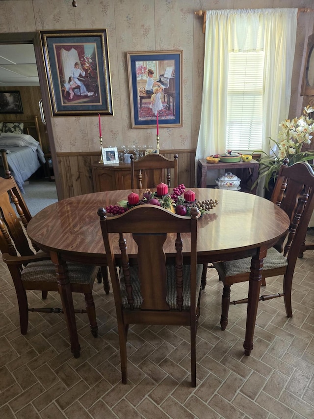 dining room with wooden walls