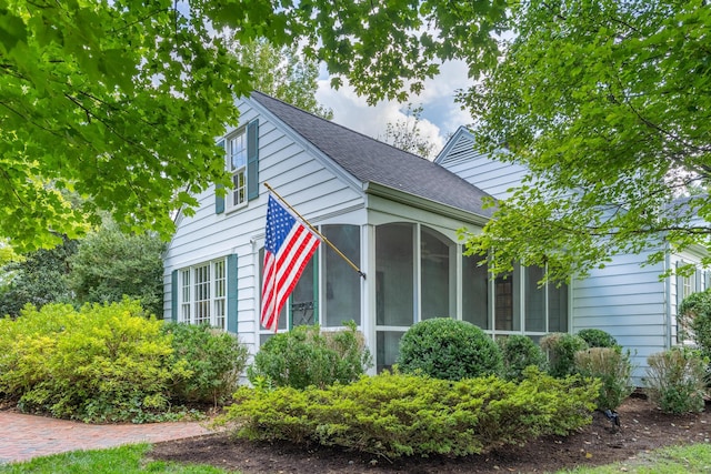 view of property exterior featuring a sunroom