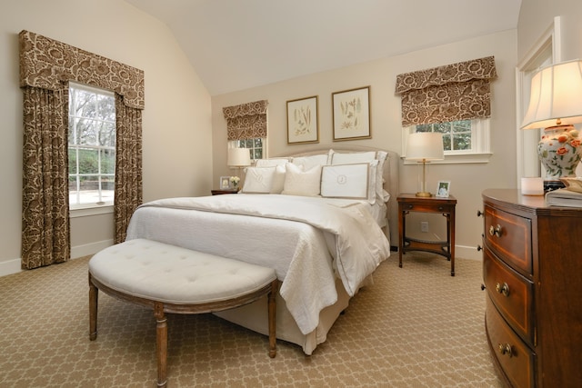 carpeted bedroom featuring lofted ceiling