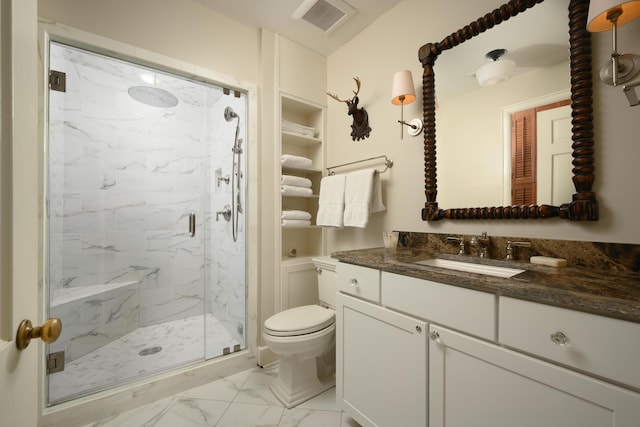 bathroom with vanity, a shower with shower door, and toilet