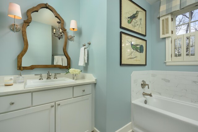 2050 Harle Ave NW, Cleveland, TN 37311 - bathroom featuring baseboards, a notable chandelier, a bath, and vanity
