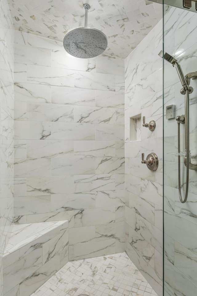 bathroom with a tile shower