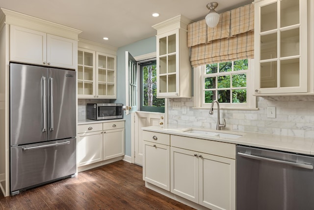 2050 Harle Ave NW, Cleveland, TN 37311 - kitchen with a sink, decorative backsplash, stainless steel appliances, dark wood-type flooring, and light countertops