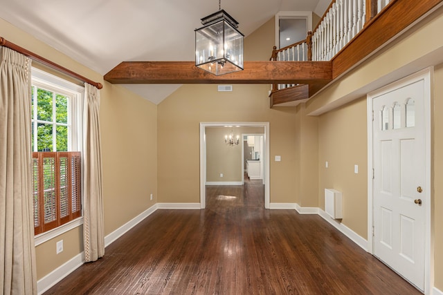 entryway with vaulted ceiling with beams, dark wood-type flooring, and a notable chandelier