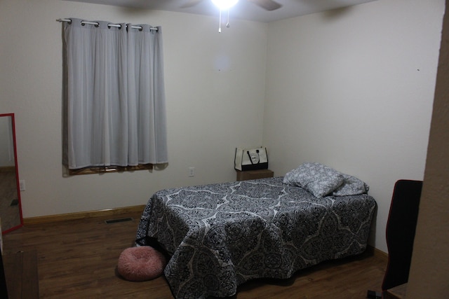 bedroom featuring ceiling fan and dark wood-type flooring