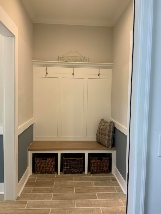 mudroom featuring light hardwood / wood-style floors and crown molding