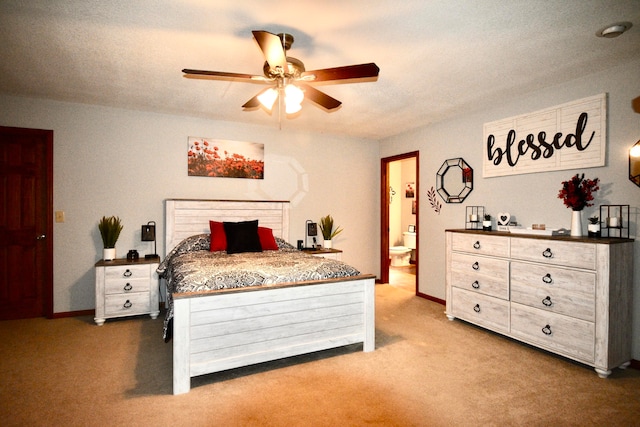 carpeted bedroom with ceiling fan, a textured ceiling, and connected bathroom