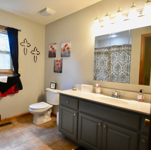 bathroom with vanity, tile patterned flooring, and toilet