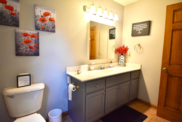 bathroom featuring vanity, toilet, and tile patterned floors