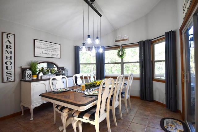 dining space featuring lofted ceiling, a chandelier, and tile patterned floors